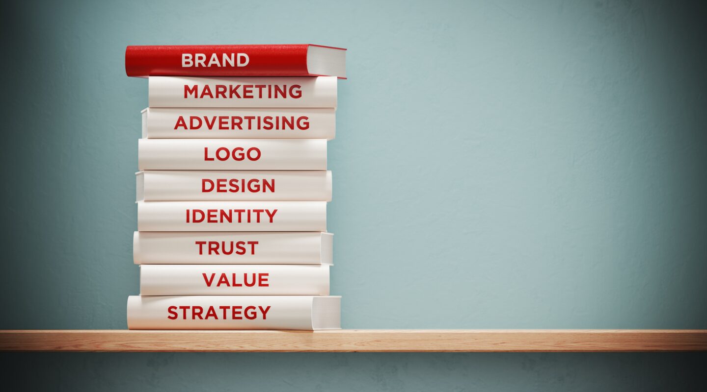 Books of Advertising And Branding In Front Grey Wall